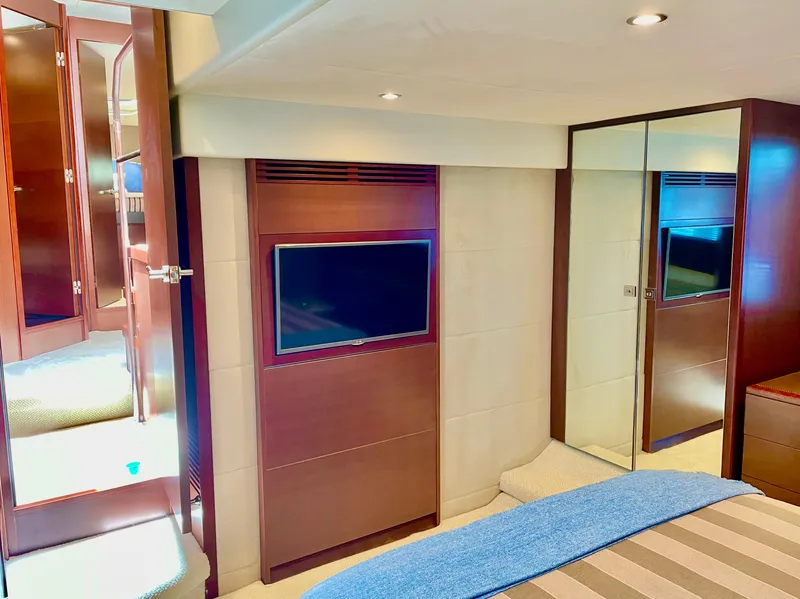 Slide: The Image of Luxurious interior of 2015 Princess f56 yacht with TV and mirrored closet. - 16
