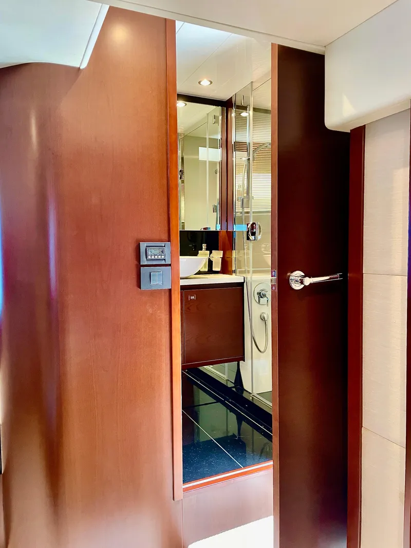 Slide: The Image of Luxurious yacht bathroom with wooden door, modern fixtures, and elegant design, Princess f56, 2015 model. - 17