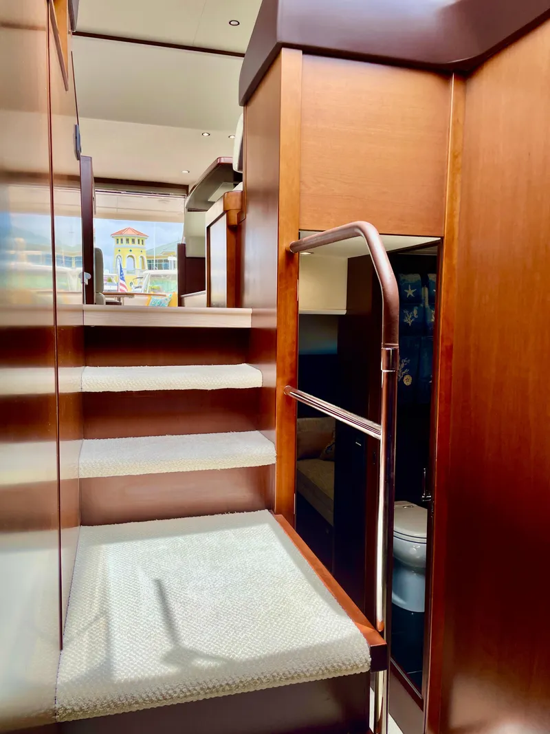 Slide: The Image of Interior staircase of 2015 Princess f56 yacht with wooden finish and carpeted steps. - 21