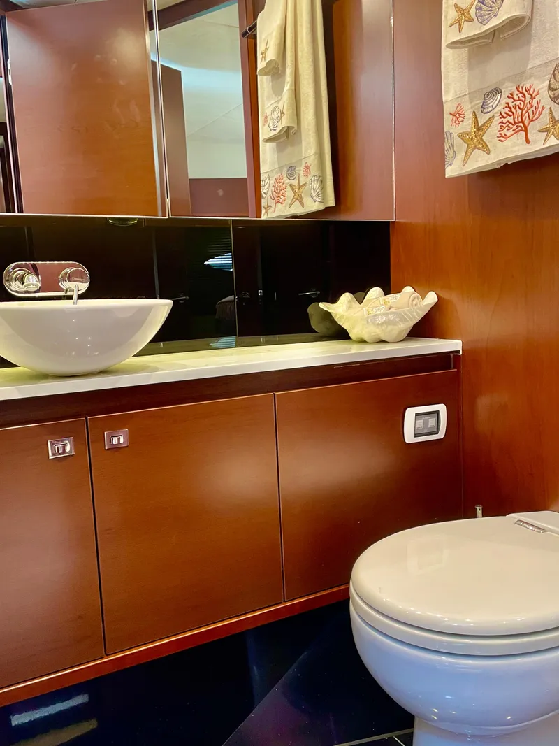 Slide: The Image of Luxurious yacht bathroom with modern sink, wooden cabinetry, and elegant decor. Princess f56, 2015 model. - 22