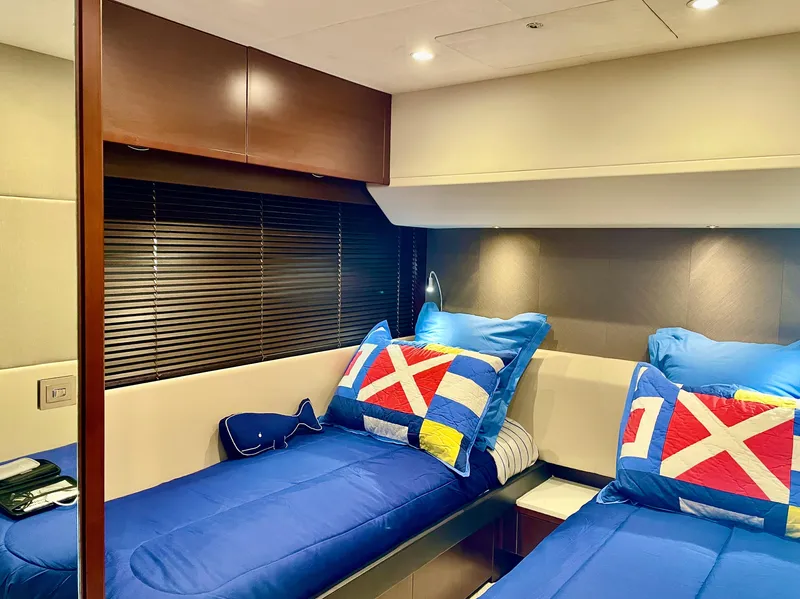 Slide: The Image of Luxurious 2015 Princess f56 yacht cabin with twin beds and nautical-themed decor. - 23