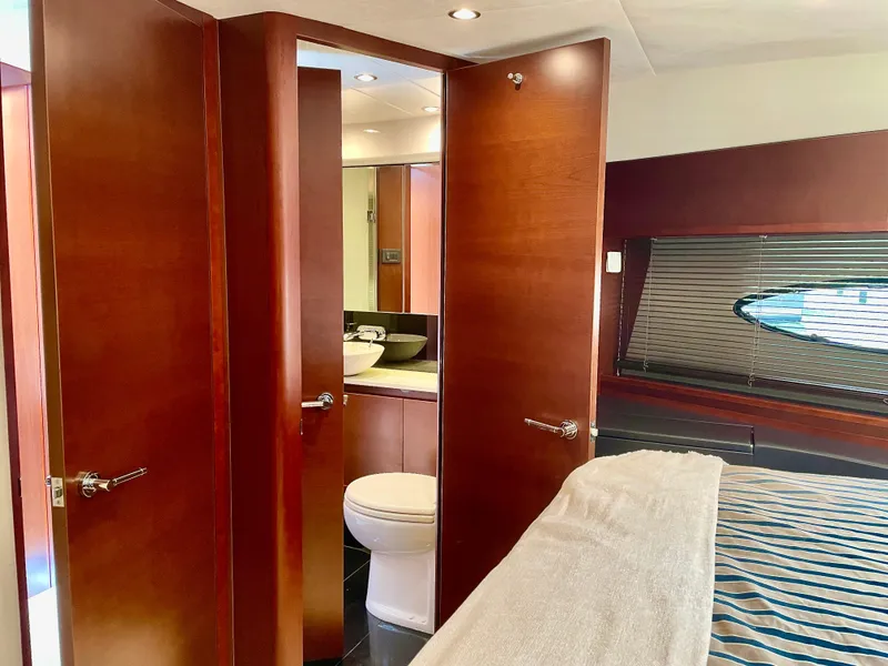 Slide: The Image of Luxurious 2015 Princess f56 yacht interior with wooden doors, modern bathroom, and cozy bedroom. - 26