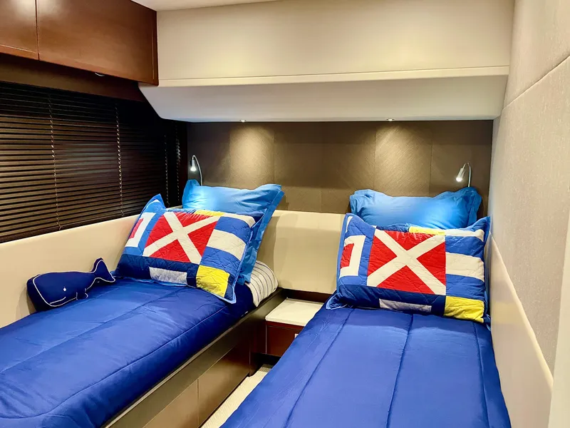 Slide: The Image of Twin beds with nautical-themed pillows in a 2015 Princess f56 yacht cabin. - 28