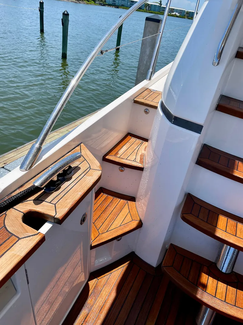Slide: The Image of Staircase on 2015 Princess F56 yacht with wooden steps and railing, overlooking water. - 36