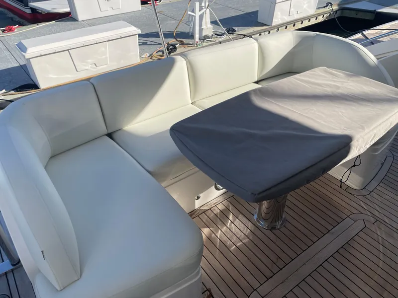 Slide: The Image of Luxurious seating area on 2015 Princess f56 yacht with covered table and white cushions. - 37