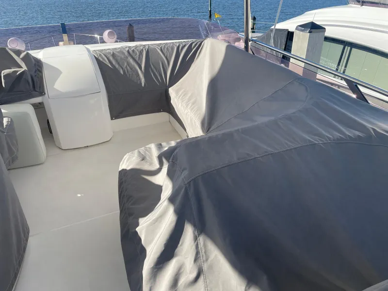 Slide: The Image of Covered seating area on a 2015 Princess f56 yacht, docked by the water. - 40