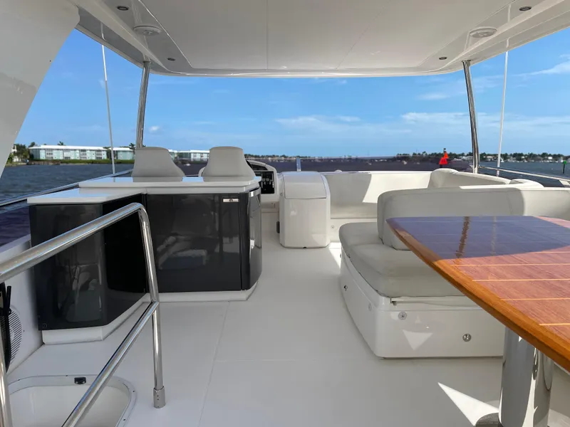 Slide: The Image of Luxurious 2015 Princess F56 yacht interior with seating and table, overlooking serene waters. - 41