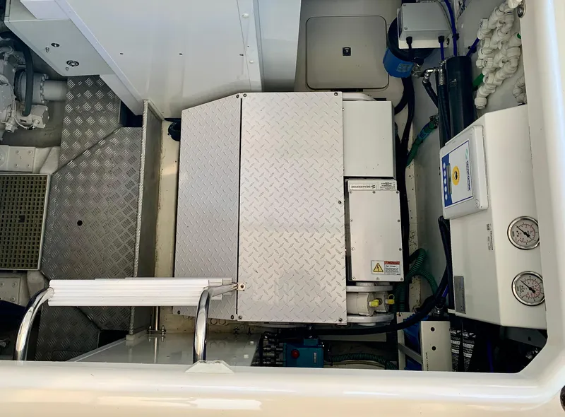 Slide: The Image of Engine compartment of a 2015 Princess f56 yacht, featuring mechanical components and control panels. - 42