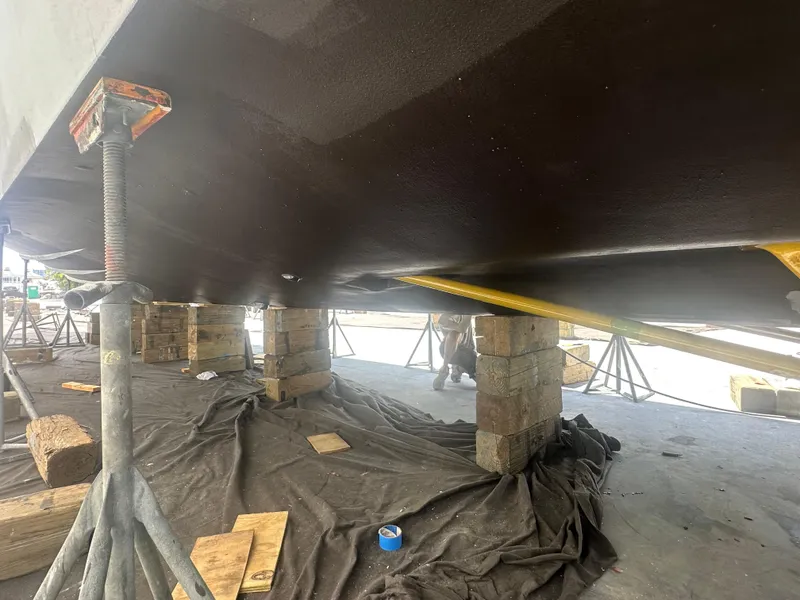 Slide: The Image of Underneath view of a 2015 Princess f56 yacht supported by blocks and stands. - 46