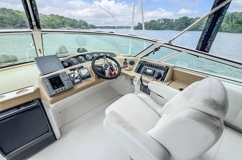 Slide: The Image of 2002 Carver 350 MARINER helm with modern controls, overlooking serene waters. - 12