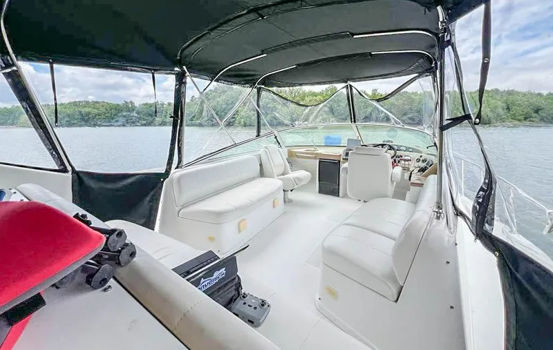 Slide: The Image of Interior view of 2002 Carver 350 MARINER boat with seating and canopy on a lake. - 13