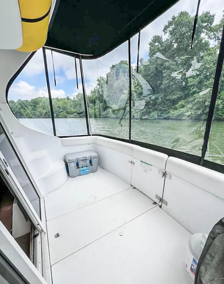 Slide: The Image of 2002 Carver 350 MARINER boat interior with river view and lush greenery. - 15