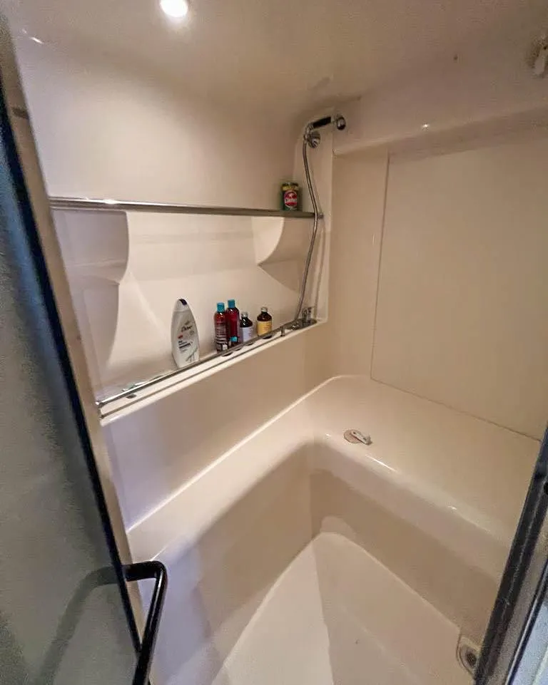 Slide: The Image of 2002 Carver 350 MARINER bathroom with shower, shelf, and toiletries. - 18