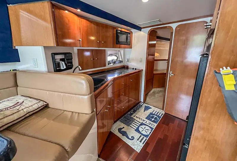 Slide: The Image of Interior of 2002 Carver 350 MARINER yacht with kitchen and seating area. - 22