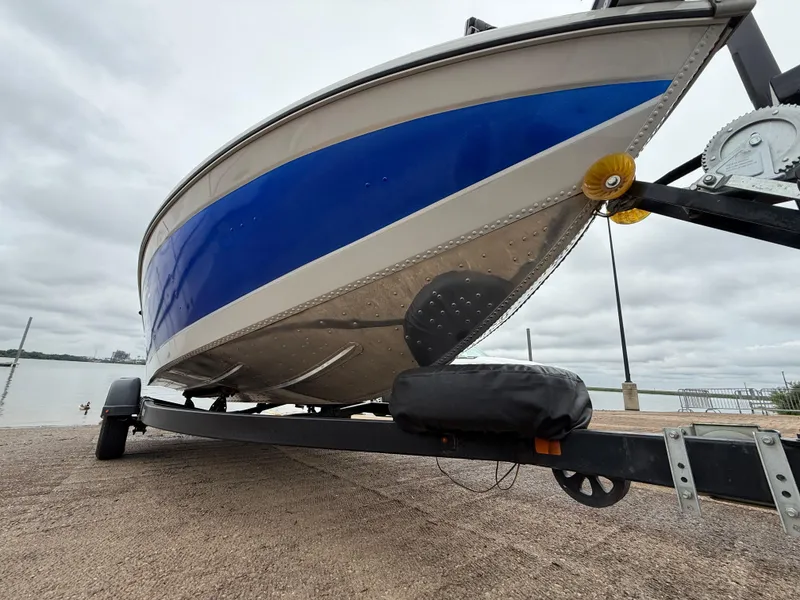 Slide: The Image of 2002 Lowe Sea Nymph V Series FM 180 boat on trailer by the water. - 13