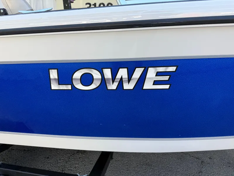 Slide: The Image of 2002 Lowe Sea Nymph V Series FM 180 boat with Johnson motor, blue and white design. - 20
