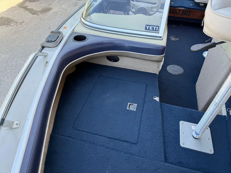 Slide: The Image of 2002 Lowe Sea Nymph V Series FM 180 boat interior with blue carpet and mounted equipment. - 36