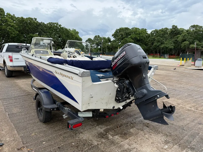 Slide: The Image of 2002 Lowe Sea Nymph V Series FM 180 boat on trailer with Johnson outboard motor. - 5