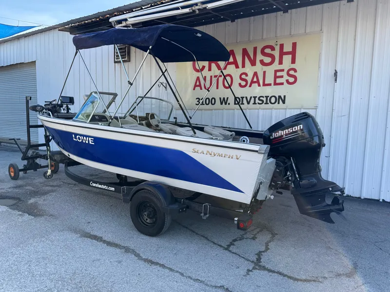 Slide: The Image of 2002 Lowe Sea Nymph V Series FM 180 boat with Johnson motor on trailer. - 50