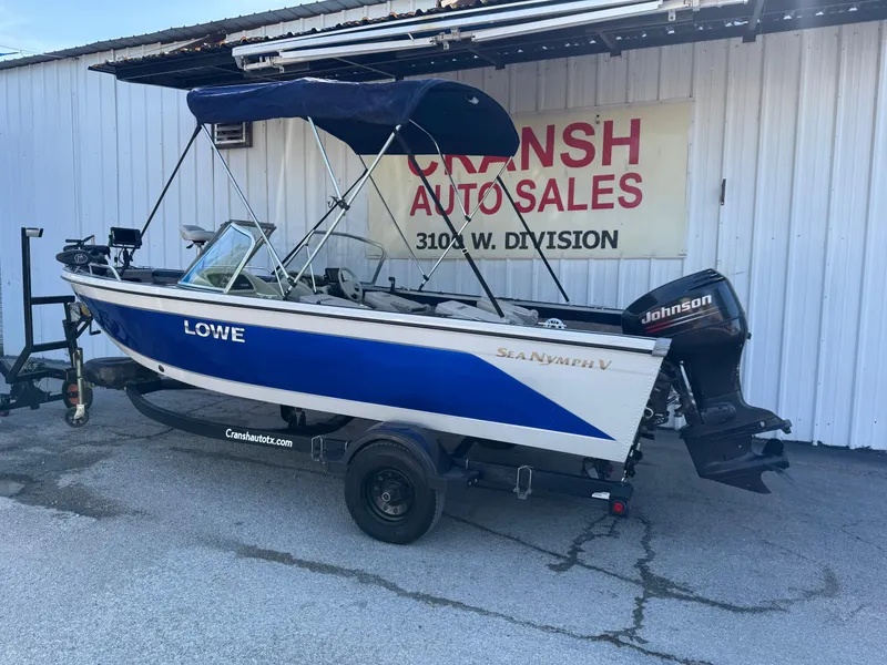 Slide: The Image of 2002 Lowe Sea Nymph V Series FM 180 boat with trailer, parked outside dealership. - 52
