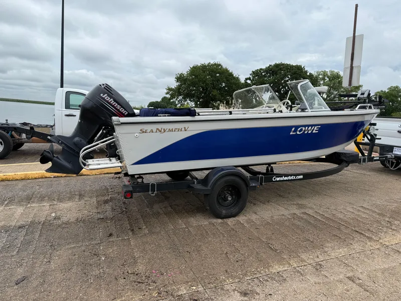 Slide: The Image of 2002 Lowe Sea Nymph V Series FM 180 boat on trailer with Johnson outboard motor. - 8
