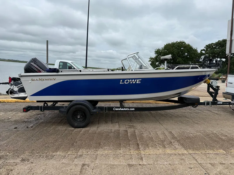 Slide: The Image of 2002 Lowe Sea Nymph V Series FM 180 boat on trailer, parked outdoors. - 9