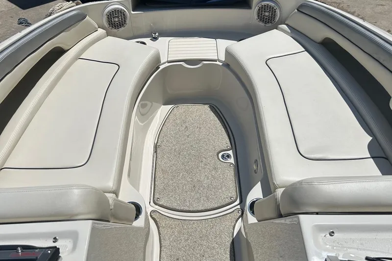 Slide: The Image of 2010 Sea Ray 260 Sundeck interior with spacious seating and carpeted flooring. - 11