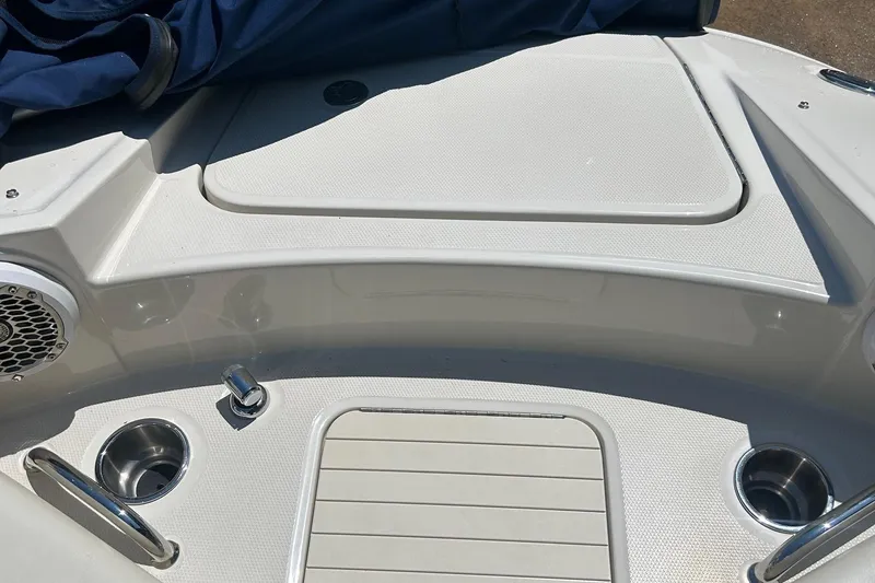 Slide: The Image of 2010 Sea Ray 260 Sundeck boat deck with cup holders and speaker. - 12