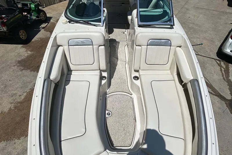 Slide: The Image of 2010 Sea Ray 260 Sundeck boat interior with white seating and open deck layout. - 13
