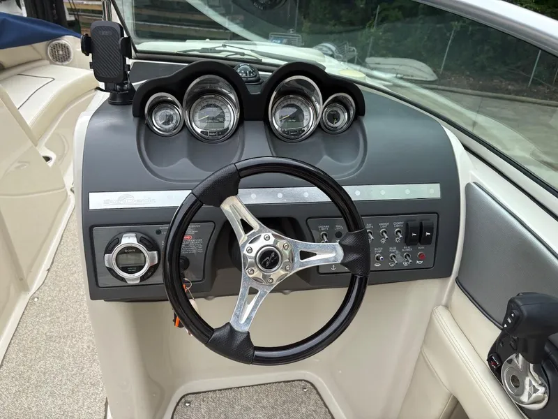 Slide: The Image of Steering console of a 2010 Sea Ray 260 Sundeck boat with gauges and controls. - 17
