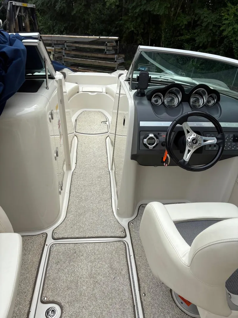 Slide: The Image of 2010 Sea Ray 260 Sundeck interior with steering wheel and dashboard, featuring modern gauges. - 18