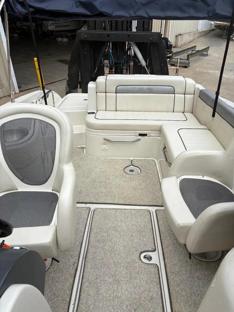 Slide: The Image of Interior of a 2010 Sea Ray 260 Sundeck boat with seating and carpeted floor. - 19