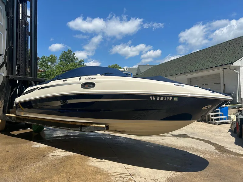 Slide: The Image of 2010 Sea Ray 260 Sundeck boat on a lift, sunny day, blue sky. - 3