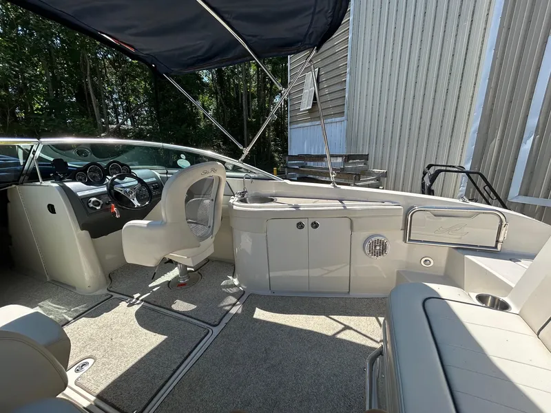 Slide: The Image of 2010 Sea Ray 260 Sundeck interior with seating and helm, under a canopy. - 5