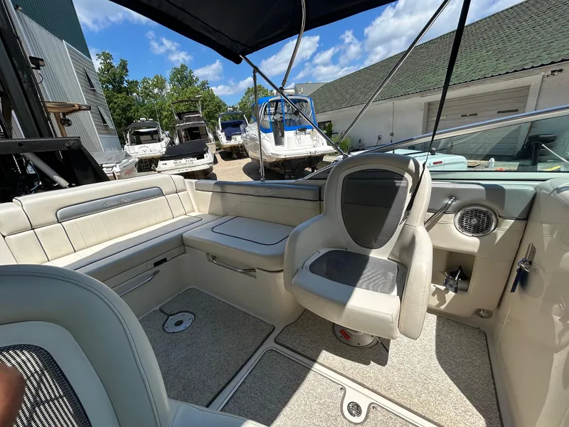 Slide: The Image of 2010 Sea Ray 260 Sundeck interior with seating, under sunny sky. - 6