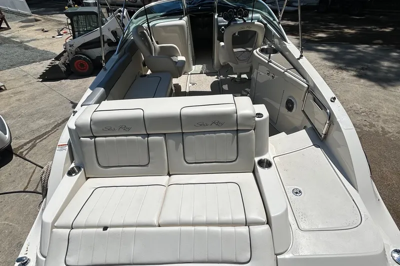 Slide: The Image of 2010 Sea Ray 260 Sundeck boat interior with white seating and spacious layout. - 9