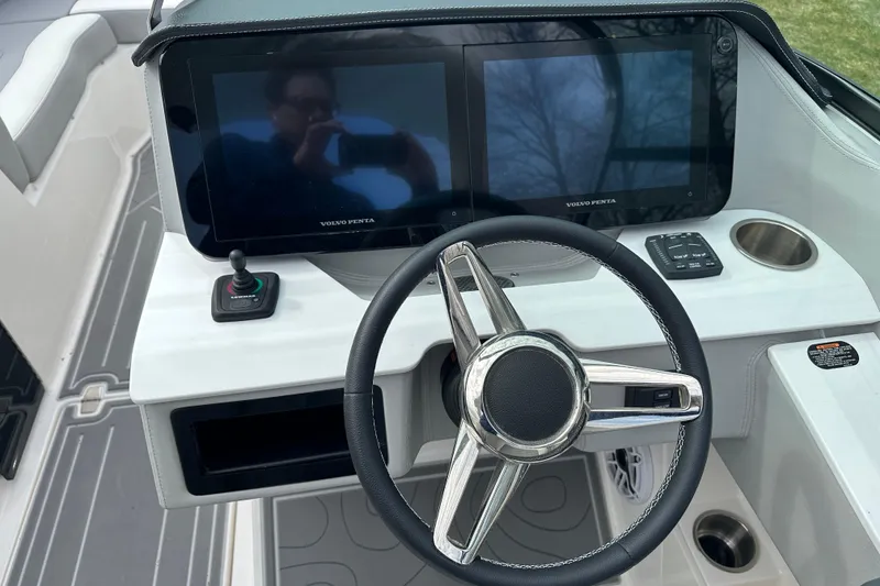 Slide: The Image of 2026 Regal LS9 boat dashboard with dual Volvo Penta displays and joystick control. - 11