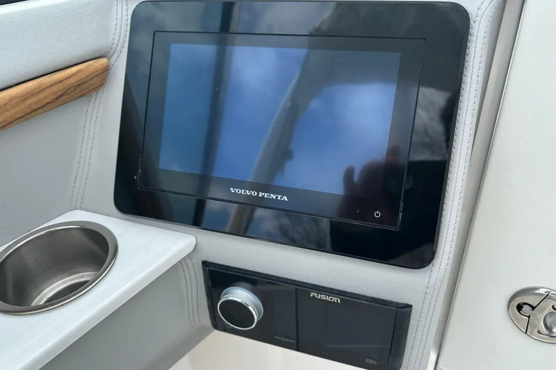 Slide: The Image of Control panel of 2026 Regal LS9 boat featuring Volvo Penta display and Fusion audio system. - 13