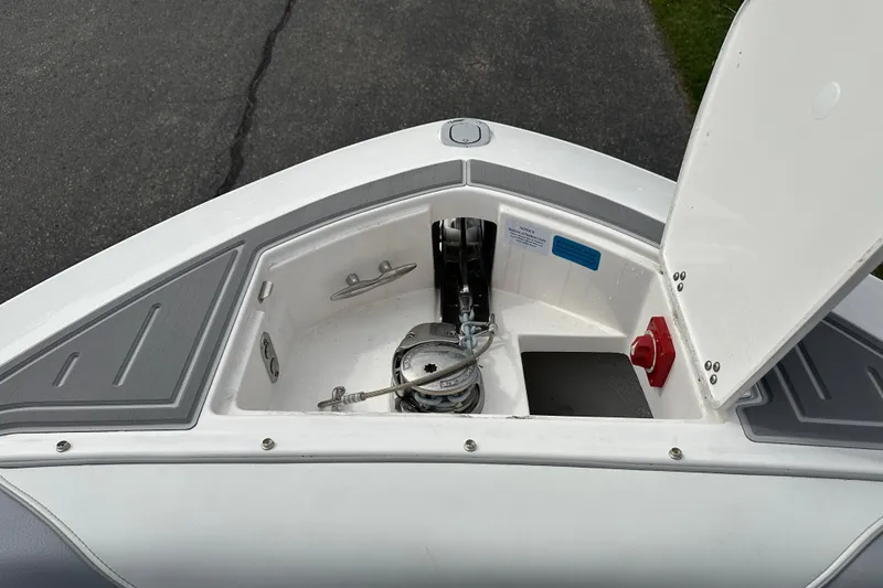 Slide: The Image of Open anchor compartment on 2026 Regal LS9 boat, showcasing storage and equipment. - 16