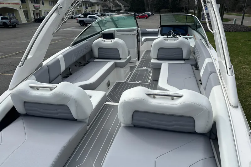 Slide: The Image of 2026 Regal LS9 boat interior with sleek gray and white seating, parked outdoors. - 6