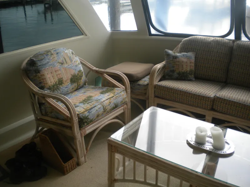 Slide: The Image of Interior of 1987 Hatteras 53 Motor Yacht with wicker furniture and glass table. - 10