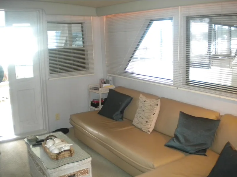 Slide: The Image of Interior of 1987 Hatteras 53 Motor Yacht with beige sofa and large windows. - 12