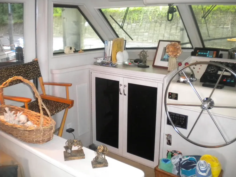 Slide: The Image of Interior of 1987 Hatteras 53 Motor Yacht with helm, chair, and decorative items. - 14