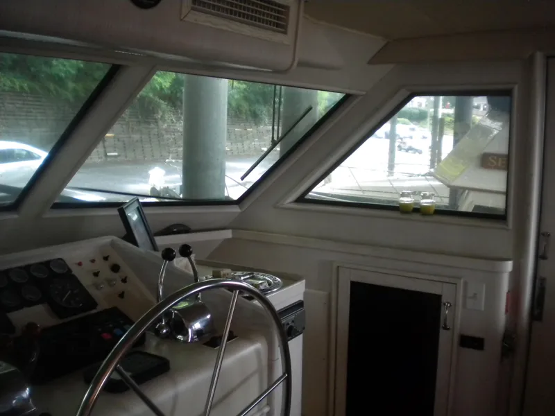 Slide: The Image of Interior helm of 1987 Hatteras 53 Motor Yacht with steering wheel and controls. - 15