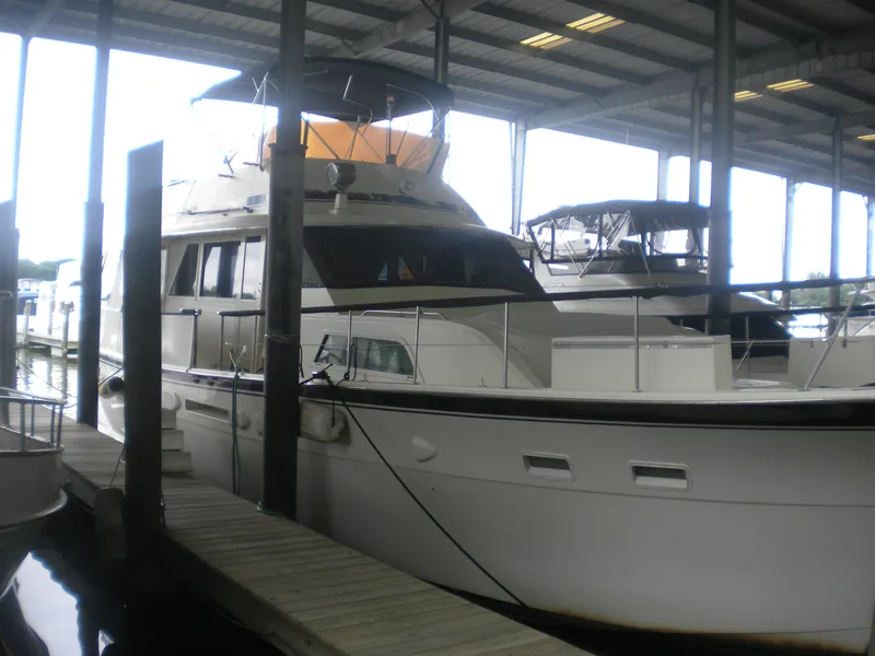 Slide: The Image of 1987 Hatteras 53 Motor Yacht docked in a covered marina. - 2
