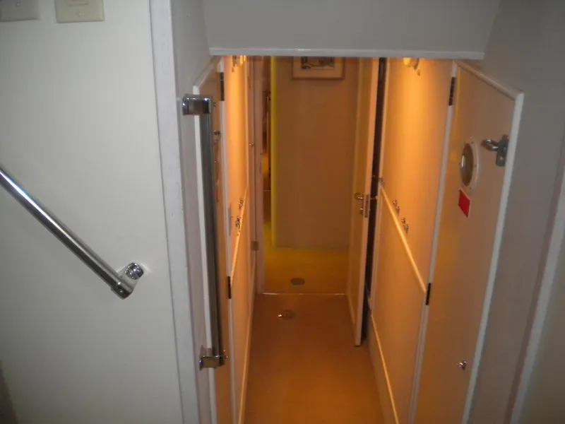 Slide: The Image of Interior hallway of a 1987 Hatteras 53 Motor Yacht, featuring doors and handrails. - 26