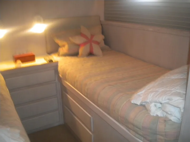 Slide: The Image of Cozy bedroom in 1987 Hatteras 53 Motor Yacht with twin beds and soft lighting. - 28
