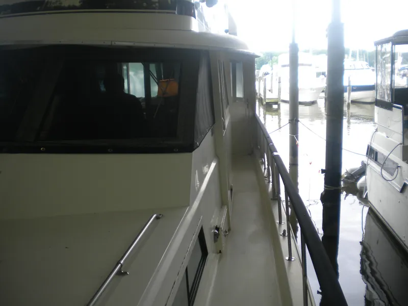 Slide: The Image of 1987 Hatteras 53 Motor Yacht docked, side view with railing and windows. - 3
