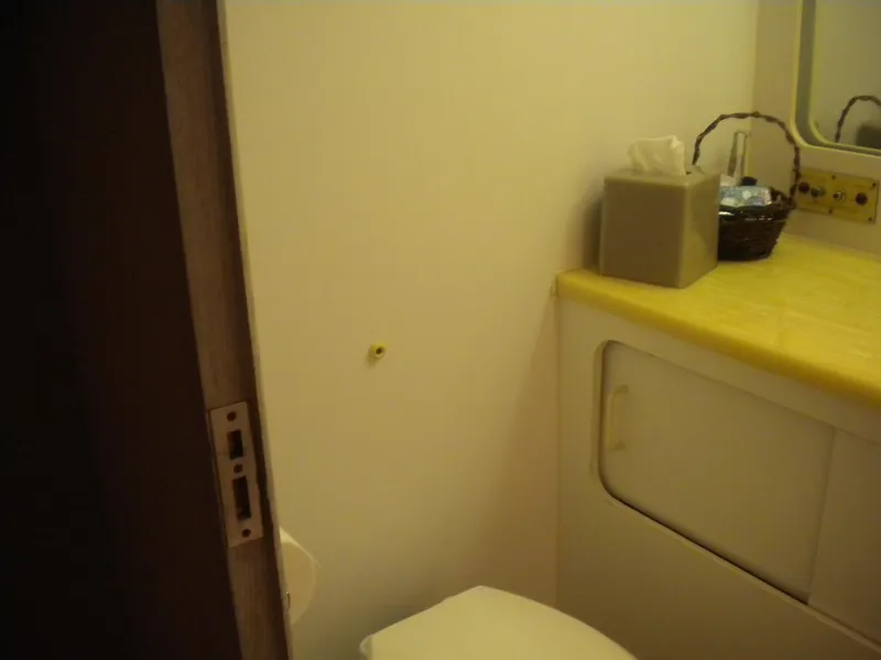 Slide: The Image of 1987 Hatteras 53 Motor Yacht bathroom with yellow countertop and tissue box. - 30