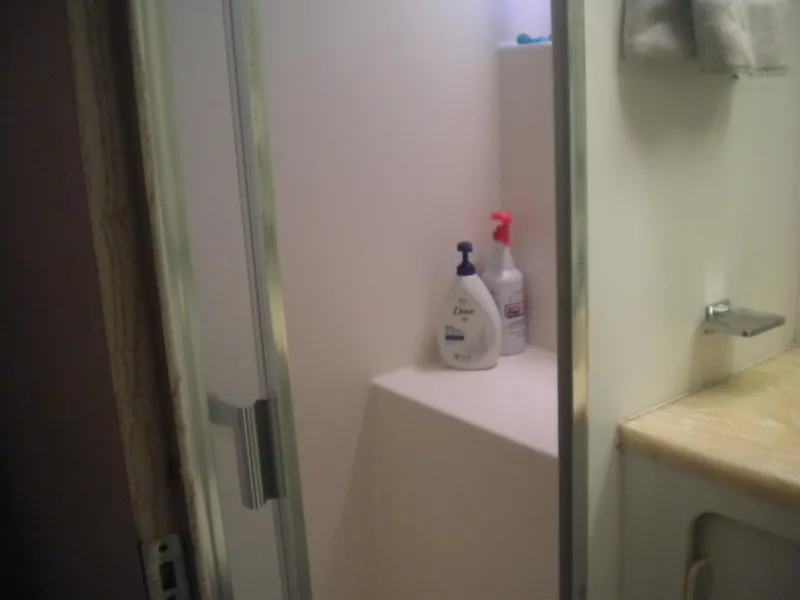 Slide: The Image of Shower area in 1987 Hatteras 53 Motor Yacht with toiletries on shelf. - 31